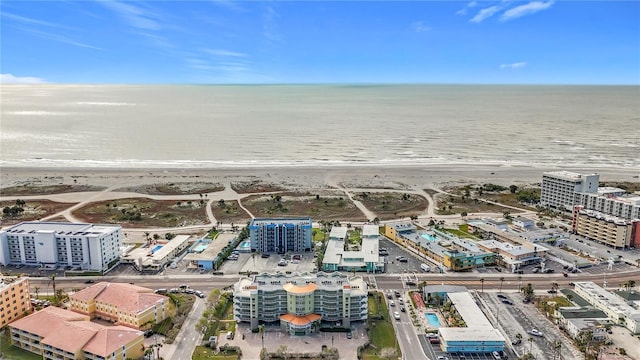 drone / aerial view featuring a water view and a beach view