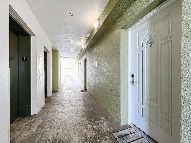 corridor featuring a textured ceiling