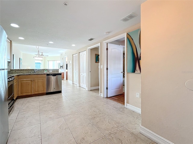 kitchen with sink, dishwasher, electric range oven, kitchen peninsula, and light tile patterned flooring