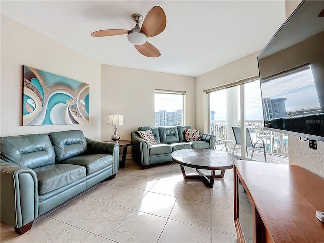 tiled living room featuring ceiling fan