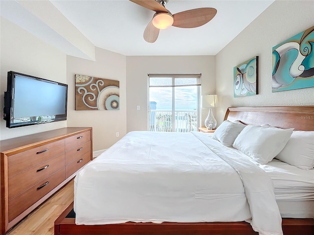 bedroom featuring access to outside, ceiling fan, and light hardwood / wood-style floors