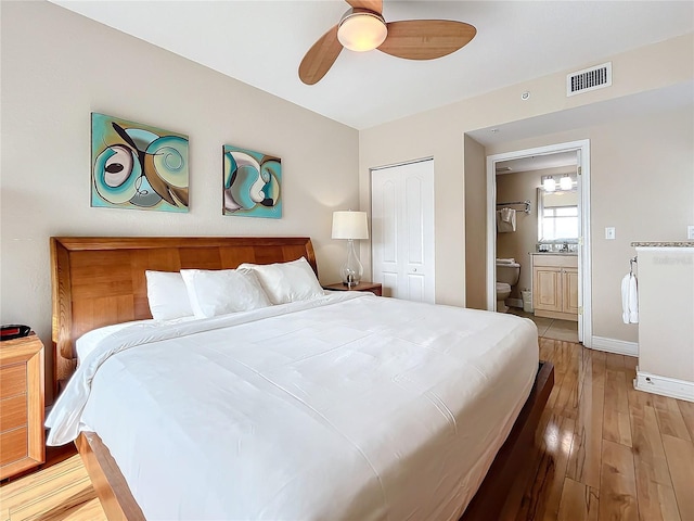 bedroom with ceiling fan, light hardwood / wood-style flooring, and a closet