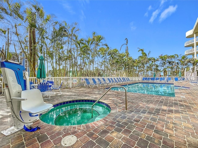 view of swimming pool with a patio area and a hot tub