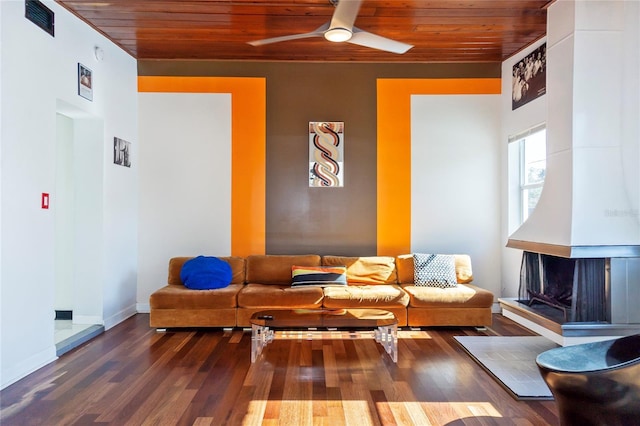 interior space with visible vents, a ceiling fan, wood finished floors, wooden ceiling, and baseboards