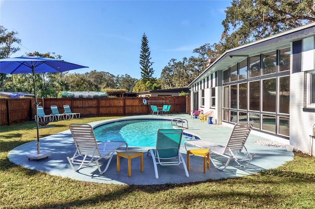 view of swimming pool with a fenced in pool, a lawn, a fenced backyard, and a patio area