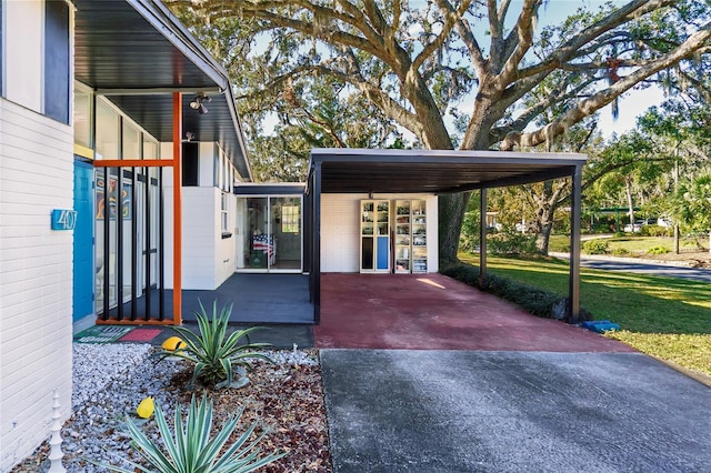 exterior space with aphalt driveway and an attached carport