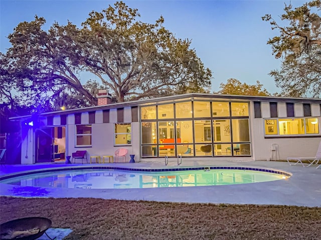 outdoor pool with a patio area