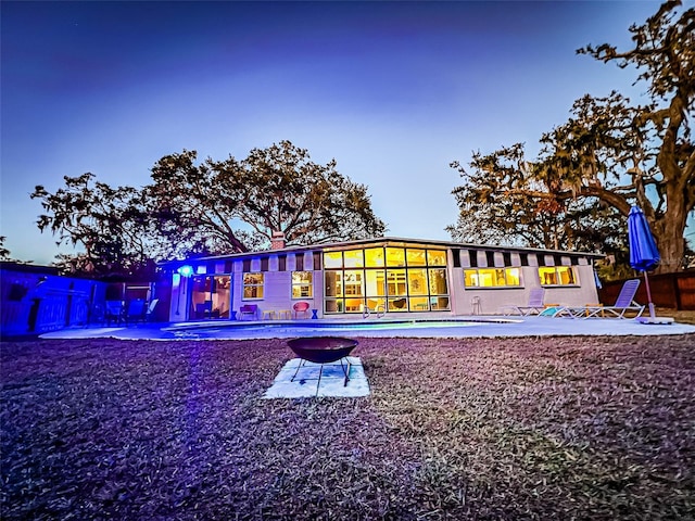 rear view of property featuring fence, a chimney, and a patio area