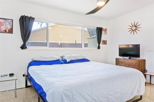 bedroom with baseboards, speckled floor, and ceiling fan