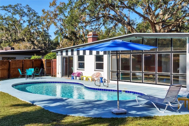 view of swimming pool featuring a patio area, a fenced in pool, and fence