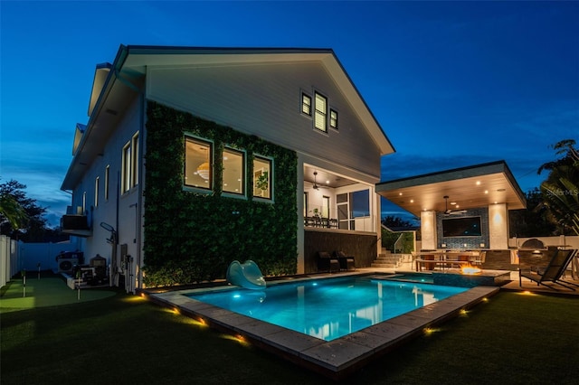 rear view of property with ceiling fan and area for grilling