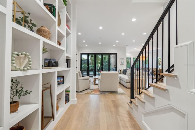 living room with light hardwood / wood-style floors and built in features