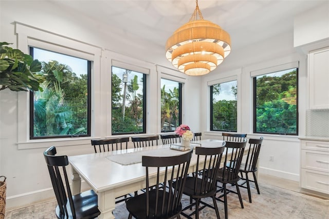 sunroom featuring a notable chandelier