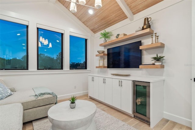 living room with vaulted ceiling with beams, light hardwood / wood-style floors, wine cooler, and wooden ceiling