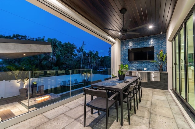 view of patio with ceiling fan and an outdoor fire pit