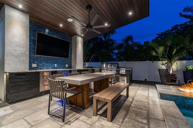 view of patio / terrace featuring an outdoor kitchen and ceiling fan