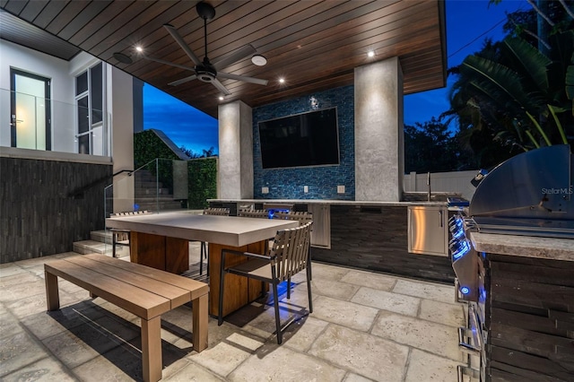 view of patio / terrace with ceiling fan, area for grilling, and an outdoor bar