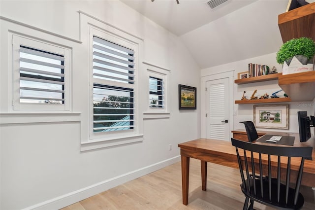 home office featuring light hardwood / wood-style flooring and vaulted ceiling