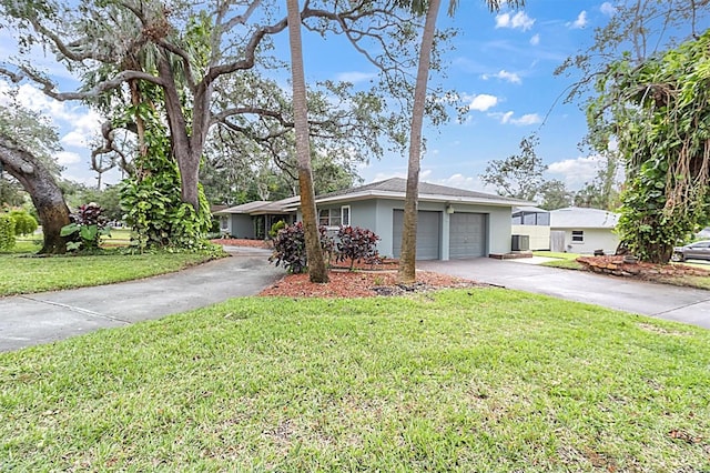 ranch-style home with a front lawn and a garage