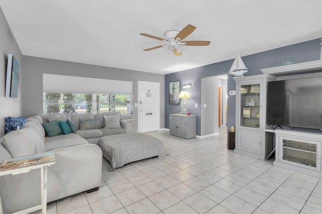 tiled living room with ceiling fan