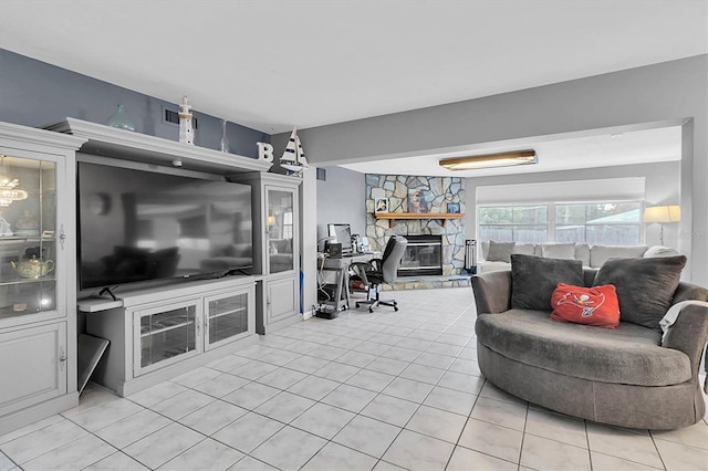 living room with a stone fireplace and light tile patterned flooring