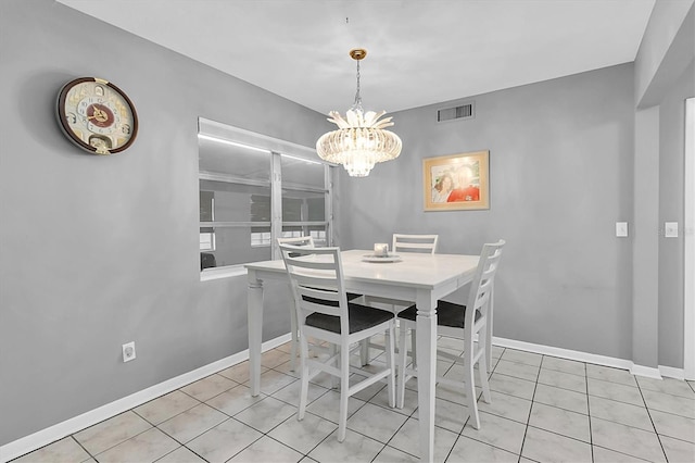 tiled dining area with a chandelier