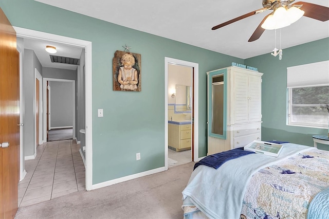 carpeted bedroom with ceiling fan and ensuite bath