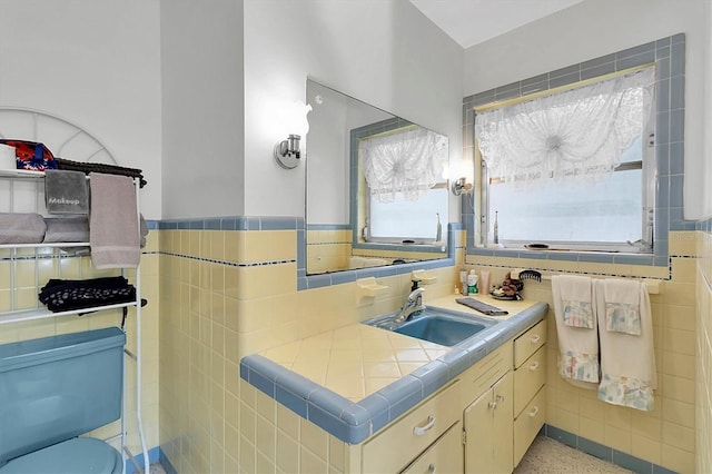 bathroom featuring vanity, tile walls, and plenty of natural light