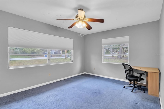 carpeted office space featuring ceiling fan and a healthy amount of sunlight