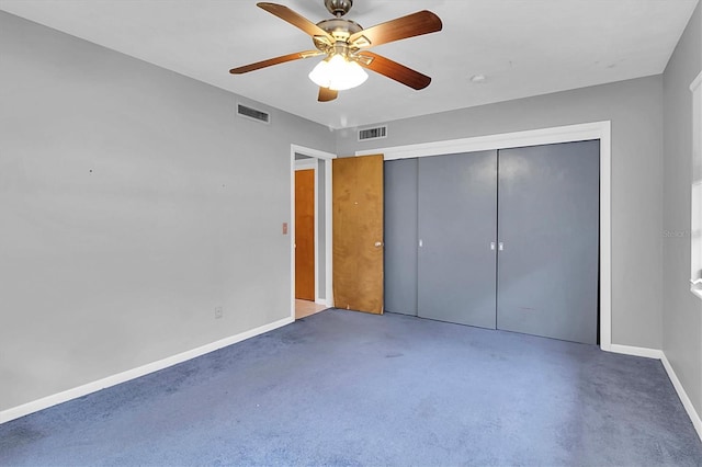 unfurnished bedroom with ceiling fan, concrete flooring, and a closet