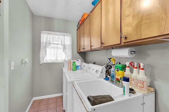 clothes washing area featuring cabinets, sink, washing machine and dryer, and light tile patterned flooring