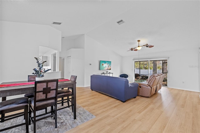 dining room featuring lofted ceiling and light hardwood / wood-style flooring