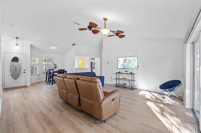 living room featuring high vaulted ceiling, light hardwood / wood-style floors, and ceiling fan