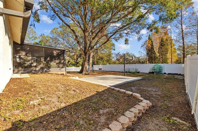 view of yard with a sunroom and a patio