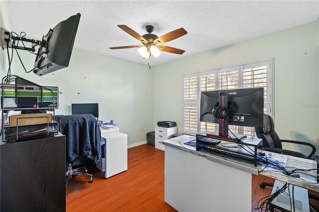 office featuring ceiling fan, hardwood / wood-style floors, and a textured ceiling