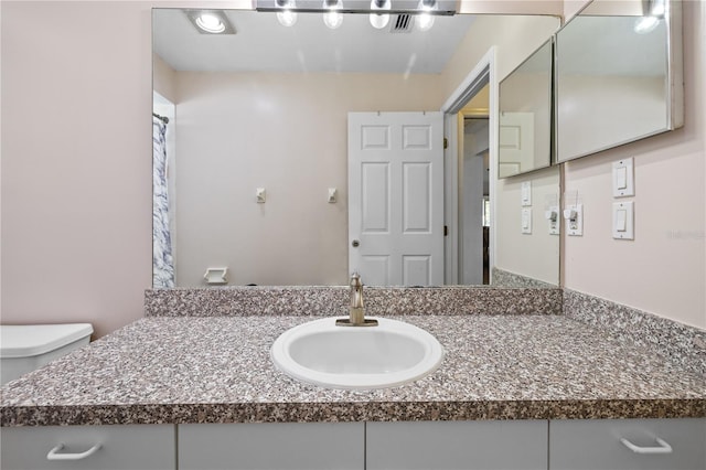 bathroom featuring vanity and toilet