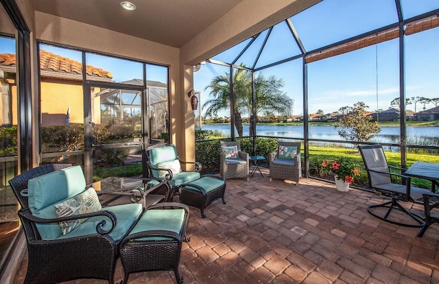 sunroom / solarium featuring a water view