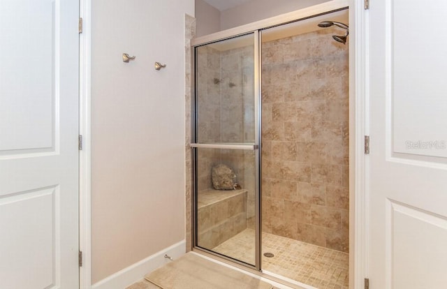 bathroom with tile patterned flooring and walk in shower