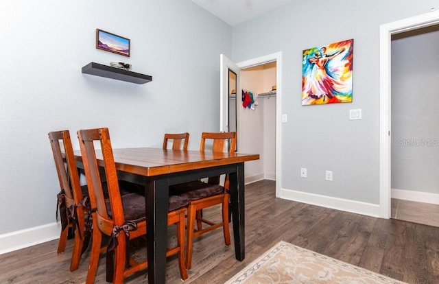 dining area featuring dark wood-type flooring