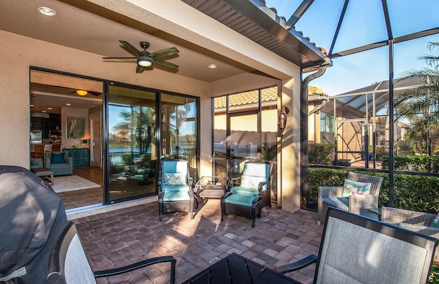 view of patio / terrace with a lanai and ceiling fan