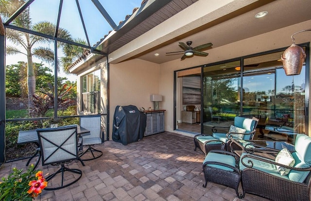 view of patio featuring ceiling fan, a lanai, and grilling area