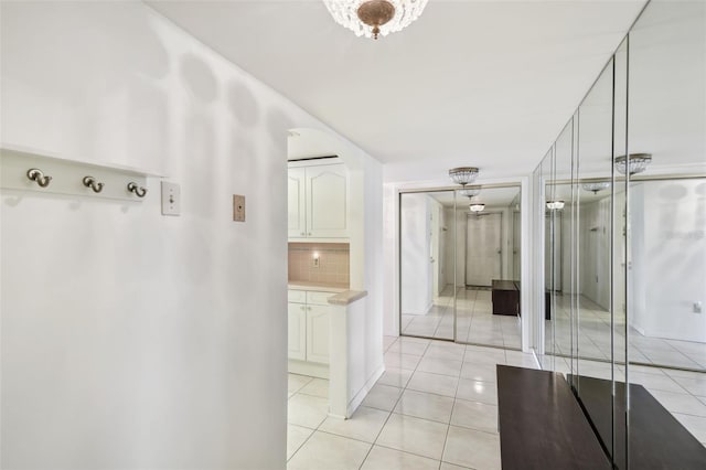 bathroom with tasteful backsplash and tile patterned flooring