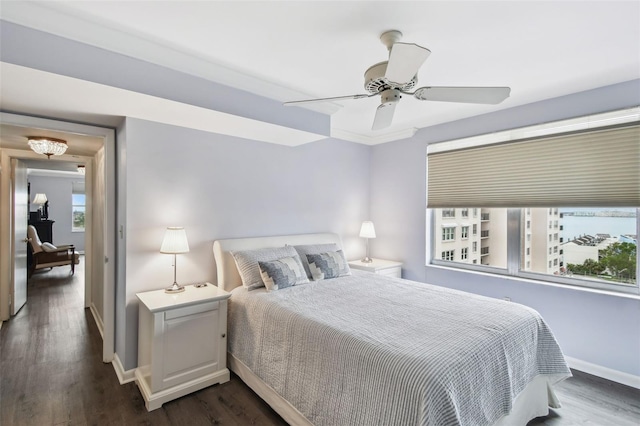 bedroom with ceiling fan and dark wood-type flooring