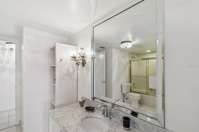 full bathroom featuring bath / shower combo with glass door, toilet, and vanity