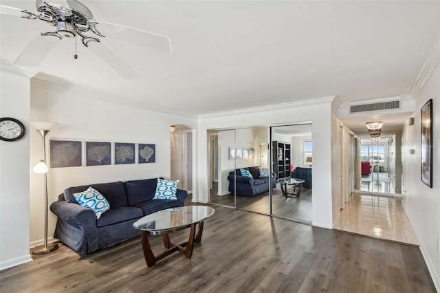 living room featuring ceiling fan, dark hardwood / wood-style flooring, and crown molding