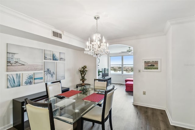 dining room with dark hardwood / wood-style floors, crown molding, and a chandelier