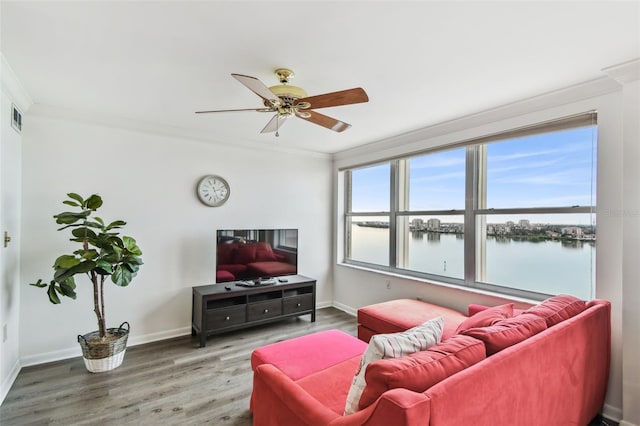 living room featuring hardwood / wood-style flooring, ceiling fan, and ornamental molding