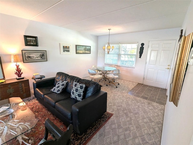 carpeted living room featuring an inviting chandelier