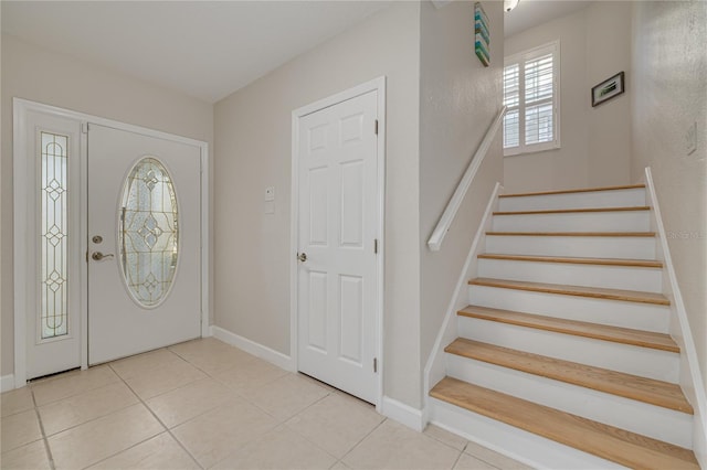 foyer entrance featuring light tile patterned flooring