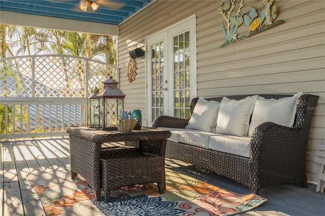 wooden terrace with outdoor lounge area and french doors